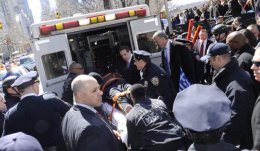 Andrew Cuomo and Bill de Blasio seen with the injured NYPD officer as he is brought into an ambulance.