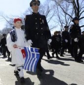 NYPD Police Capt. Chris Stilianesis, and his son Dionisios, 7, walk in the Greek Independence Day Parade on March 29, 2015 in Manhattan.